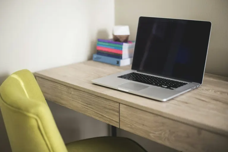 Laptop and books on a desk